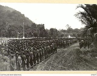 FINSCHHAFEN, NEW GUINEA, 1944-02-29. THE OFFICIAL OPENING OF THE FINSCHHAFEN WAR CEMETERY BY VX20308 MAJOR-GENERAL F.H. BERRYMAN, CBE, DSO, OFFICER COMMANDING 2ND AUSTRALIAN CORPS, WHO UNVEILED THE ..