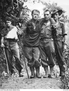 1943-08-03. NEW GUINEA. LT. HARRY GILBERT, OF FITZROY, VICTORIA, AND CPL. JOHN SMITH, OF MELBOURNE, VIC., ASSISTING PTE. JIM GEMMELL, OF CASTLEMAINE VIC., AND PTE. CHAS. HANDFORD, OF CASINO, N.S.W. ..