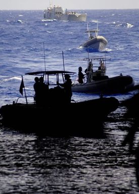 U.S. Navy Sailors aboard several Rigid Hull Inflatable Boats and Landing Craft Utility 1658 wait to enter the well deck of the Tarawa Class Amphibious Assault Ship USS SAIPAN (LHA 2) during operations in the Mediterranean Sea on Aug. 31, 2006. SAIPAN is currently underway conducting maritime security operations. (U.S. Navy photo Mass Communication SPECIALIST Second Class Steven J. Weber) (Released)