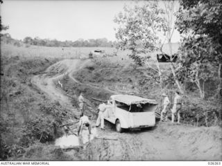 PAPUA, 1942-08-18. TRUCK CONVEYING STAFF OF THE AUSTRALIAN BROADCASTING COMMISSION (ABC) AND PRESS CORRESPONDENTS BOGGED IN THE FORWARD AREA