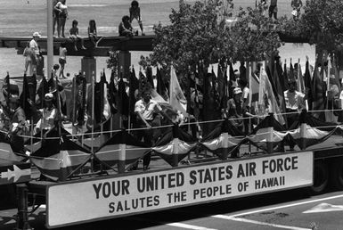 Members of various local Air Force units ride the Air Force float in the Kamehameha Day Parade