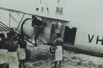 Pilot checking oil, Norseman, Green River, [Papua New Guinea], 1954