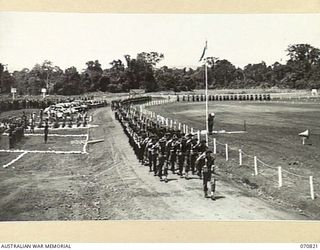 LAE, NEW GUINEA, 1944-03-08. A GENERAL VIEW OF THE MARCH PAST, HEADQUARTERS, 29TH INFANTRY BRIGADE AS VX20308 MAJOR-GENERAL F.H. BERRYMAN, CBE, DSO, GENERAL OFFICER COMMANDING 2ND AUSTRALIAN CORPS ..