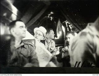 IN FLIGHT BETWEEN HOLLANDIA, DUTCH NEW GUINEA AND AITAPE, NORTH EAST NEW GUINEA. C. 1944-06. INTERIOR OF AIRCRAFT CARRYING ARTHUR DRAKEFORD, THE MINISTER FOR AIR (IN PANAMA HAT), AND HIS PARTY ..