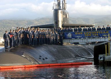 US Navy (USN) Sailors stationed aboard the LOS ANGELES CLASS: Attack Submarine USS LOUISVILLE (SSN 724), stand on the deck of the ship and poses for a group photograph after receiving the Battle E award at Naval Base Pearl Harbor, Hawaii (HI). The Battle "E" award recognizes sustained superior performance in all areas of combat readiness
