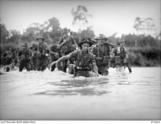 MALAS RIVER, NEW GUINEA. 1944-05-27. FORWARD TROOPS OF THE 35TH INFANTRY BATTALION CROSSING RAPIDS IN THE RIVER DURING THEIR ADVANCE TOWARDS WEWAK. IDENTIFIED PERSONNEL ARE:- PRIVATE S. HUMPHERY ..