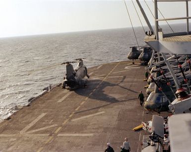 CH-46 Sea Knight helicopters are parked on the flight deck of the amphibious assault ship USS GUAM (LPH-9) during flight operations off the coast of Beirut. The ship is providing support to U.S. Marines deployed in Lebanon as part of a multi-national peacekeeping force following confrontation between Israeli forces and the Palestine Liberation Organization