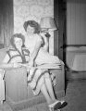 Pen pals, two women looking at book, Padua, IL 1951