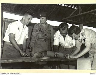 LAE, NEW GUINEA. 1945-03-27. LADY WAKEHURST (2), EXAMINING THE HAND CRAFTS SECTION OF THE RED CROSS RECREATION HUT. IDENTIFIED PERSONNEL ARE:- VX121719 SIGNALMAN R.A. ORFORD (1); VX11092 CORPORAL ..