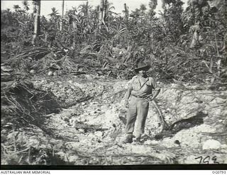 LOS NEGROS ISLAND, ADMIRALTY ISLANDS. 1944-03-18. OF AN UNIDENTIFIED RAAF AIRMAN STANDING IN WHAT MAY BE A BOMB CRATER (SEE ALSO OG0791)