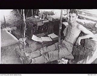 MARKHAM VALLEY, NEW GUINEA. C.1945. SERGEANT N. (NAT) F. DANIELL, MOBILE PROPAGANDA UNIT, FAR EASTERN LIAISON OFFICE, INSIDE HIS TENT WITH A RADIO USED TO PICK UP AUSTRALIAN BROADCASTS TO BE USED ..