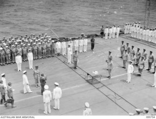 AT SEA OFF RABAUL, NEW BRITAIN. 1945-09-06. THE SURRENDER CEREMONY ON BOARD THE AIRCRAFT CARRIER HMS GLORY. GENERAL H. IMAMURA, COMMANDER EIGHTH AREA ARMY, SALUTING LIEUTENANT GENERAL V.A.H. ..