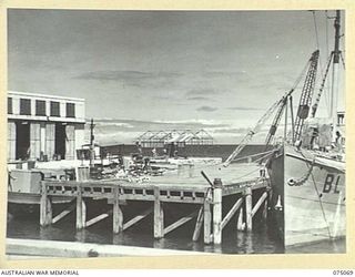 PORT MORESBY, PAPUA. 1944-08-12. THE RAN WORK JETTY. SHOWING IN THE LEFT FOREGROUND IS ONE OF THE WORKSHOPS