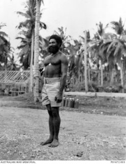 LUNGGA, GUADALCANAL, SOLOMON ISLANDS, 1943-10. SERGEANT (SGT) YAUWIKA, A MEMBER OF THE NATIVE CONSTABULARY, AT THE HEADQUARTERS CAMP OF THE DEPUTY SUPERVISING INTELLIGENCE OFFICER (DSIO), NAVAL ..