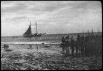 Group of natives by the shore; Zaca in the distance