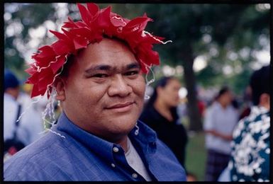 Man wearing colourful head adornment