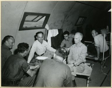 Photograph of Ernie Pyle Interviewing Combat Photographers at Guam