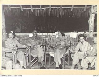 LAE, NEW GUINEA. 1945-09-24. A GROUP OF AUSTRALIAN ARMY MEDICAL WOMEN'S SERVICE AND THEIR FRIENDS RELAXING BETWEEN DANCES AT A BUFFET DINNER AND DANCE HELD BY QUEENSLAND AUSTRALIAN ARMY MEDICAL ..