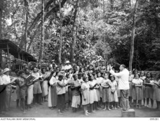 Bitagalip, Ramale Mission, New Britain. The Mission Choir practising for Christmas festivities, conducted by Father Reischl
