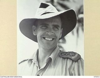 PORT MORESBY, PAPUA, NEW GUINEA, 1944-02-14. CAPTAIN ROBIN WOOD, THE STATION SUPERVISOR AND OFFICER- IN- CHARGE OF "9PA" AUSTRALIAN BROADCASTING COMMISSION BROADCASTING STATION