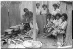 Christian women in a kitchen with walls of iron roofing