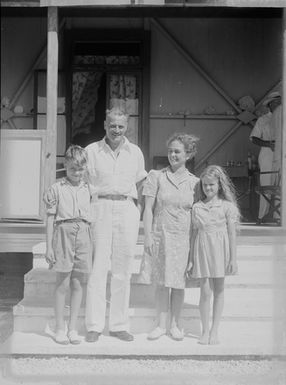 [Group portrait outside a house]