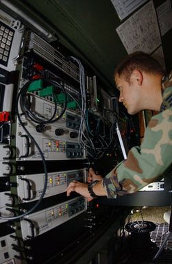 US Air Force (USAF) SENIOR AIRMAN (SRA) Jeff Williams works on the controls of the Lightweight Multiband Satellite Terminal (LMST) during a two week Exercise Multi Thunder held at Barbers Point Coast Guard Base (CGB) in Hawaii (HI)