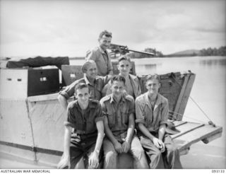 SORAKEN AREA, BOUGAINVILLE, 1945-06-12. MEMBERS OF 42 LANDING CRAFT COMPANY PLAYED A HEROIC PART IN EVACUATING 31/51 INFANTRY BATTALION TROOPS FROM PORTON PLANTATION. THE CREW (PICTURED) OF AB728, ..