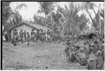 Returned laborers, purification ritual: in front of house built by returned laborers, preparations for sacrifical feast are made