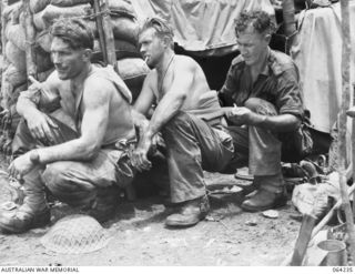 SHAGGY RIDGE, NEW GUINEA. 1944-01-22. REGIMENTAL AID POST ORDERLY QX24494 PRIVATE J.A. BYRNE, 2/9TH INFANTRY BATTALION (3) TREATING WOUNDED DURING THE BATTLE FOR SHAGGY RIDGE. THEY ARE:- QX16556 ..