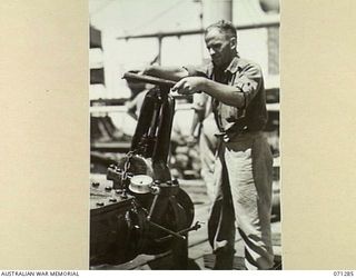 PORT MORESBY, PAPUA, 1944-03-21. WX35725 PRIVATE G.S. MORGAN (1), OF THE 1ST BULK PETROLEUM STORAGE COMPANY, (NEW GUINEA FORCE), AT THE WHEEL ON THE NON RETURN VALVE POSITIONED ON THE MAIN OIL ..