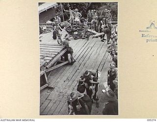 THE WHARF, JACQUINOT BAY, NEW BRITAIN, 1945-08-13. HEADQUARTERS 5 DIVISION TROOPS EMBARKING ABOARD THE TROOPSHIP VAN OUTHOORN FOR RETURN TO AUSTRALIA