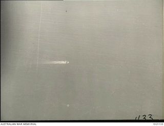 NEAR WEWAK. C. 1944-06. AERIAL VIEW OF A CATALINA FLYING BOAT RESCUING FROM THE SEA FLIGHT SERGEANT G. S. MOGG, MUDGEE, NSW, AN RAAF KITTYHAWK PILOT WHO HAD TO DITCH NEAR WEWAK. THIS PHOTOGRAPH WAS ..