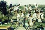 Children at party, enjoying play equipment (old frames from army trucks) partly held at Social Club House, Port Moresby,1962