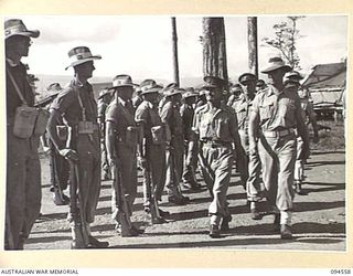 LAE AREA, NEW GUINEA, 1945-08-05. BRIGADIER P.S. MCGRATH, DEPUTY DIRECTOR OF SUPPLIES AND TRANSPORT (1), ACCOMPANIED BY SENIOR OFFICERS DURING AN INSPECTION OF NO. 77 PLATOON, 151 GENERAL TRANSPORT ..