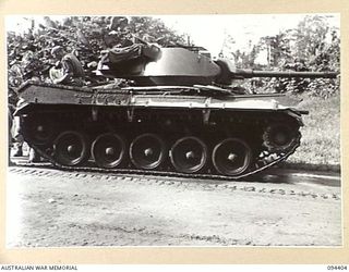 TOROKINA AREA, BOUGAINVILLE. 1945-07-23. AN M24 GENERAL CHAFFEE LIGHT TANK PICTURED DURING TESTS CONDUCTED FOR THE WAR OFFICE. NOTE CLEAN CONDITION OF SUSPENSION OF TRACKS