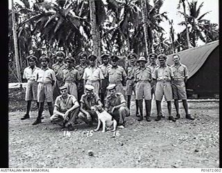 LUNGGA, GUADALCANAL, SOLOMON ISLANDS, 1943-10-14. THE DEPUTY SUPERVISING INTELLIGENCE OFFICER (DSIO), NAVAL INTELLIGENCE DIVISION, RAN, WITH HIS STAFF AND VISITING COASTWATCHERS AT HIS HEADQUARTERS ..