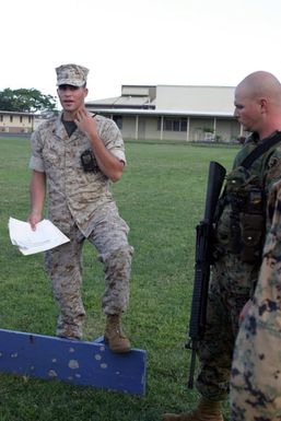 US Navy (USN) Hospital Corpsman Third Class (HM3) Munoz, Golf Company, 2nd Battalion (BN) 3rd Marine Regiment, helps to instruct the various US Marine Corps (USMC) squads going through Squad Competitions as they prepare for the Super Squad Competition