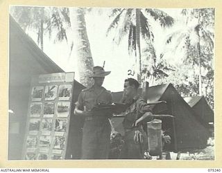 MILILAT, NEW GUINEA. 1944-08-13. VX104391 LIEUTENANT J.W. CLARKE, 106TH TANK ATTACK REGIMENT (1) CHATTING TO NX58247 SERGEANT A.L. FRAZER, MILITARY HISTORY SECTION OUTSIDE THE UNIT TENT AT ..