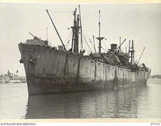 MADANG, NEW GUINEA. 1944-12-14. THE AMERICAN LIBERTY SHIP, "FRANCIS PARKMAN" PULLING OUT FROM THE WHARF WITH TROOPS AND TANKS OF THE 2/4TH ARMOURED REGIMENT ABOARD THE AITAPE