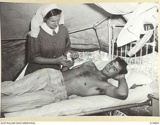 1943-05-24. NEW GUINEA. CPL. M.O. WALLENAFFER, OF MILDURA, VIC, WHO WAS WOUNDED BY A JAPANESE MACHINE GUN BULLET DURING FIGHTING IN THE MUBO AREA, WALKED 40 MILES TO WAU. HALF OF THE JOURNEY WAS ..
