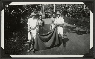 Sailors removing the white band, the insignia of the Mau, from lava lavas