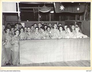 LAE, NEW GUINEA. 1945-09-05. AUSTRALIAN WOMEN'S ARMY SERVICE GUESTS ENJOYING SUPPER AND REFRESHMENTS AT THE VICTORY SOCIAL ARRANGED BY THE STAFF OF THE ARMY NEWSPAPER GUINEA GOLD