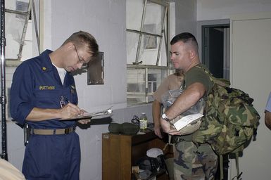 US Navy (USN) Lieutenant Commander (LCDR) Doug Putthoff (left) and USN Lieutenant (LT) Pete Obenauer, Naval Environmental and Preventive Medicine Unit 6 (NEPMU-6) check out equipment for deployment to Indonesia. NEPMU-6 is deploying to Indonesia to provide humanitarian support and conduct water quality testing, insect collection and examination for disease, and medical assistance as part of Tsunami Humanitarian Disaster Relief Effort following the 9.0 Tsunami event on December 26, 2004