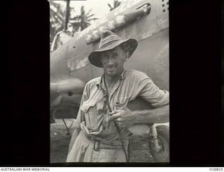 MOMOTE, LOS NEGROS ISLAND, ADMIRALTY ISLANDS. 1944-03-18. AIRCRAFTMAN E. R. "SLIM" MASTERS OF NORTH NORWOOD, SA, A FLIGHT RIGGER WITH NO. 76 (KITTYHAWK) SQUADRON RAAF, BESIDE THE AIRCRAFT NICKNAMED ..