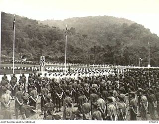 FINSCHHAFEN, NEW GUINEA, 1944-02-29. THE OFFICIAL OPENING OF THE FINSCHHAFEN WAR CEMETERY BY VX20308 MAJOR-GENERAL F.H. BERRYMAN, CBE, DSO, OFFICER COMMANDING 2ND AUSTRALIAN CORPS, WHO UNVEILED THE ..