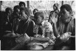 Women beating leaf packets in accompaniment of 'aubinubinu panpiping; woman at far left foreground is 'Osiabu