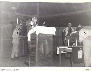 LAE, NEW GUINEA. 1944-09-18. VX354 CHAPLAIN L.M. GOLDMAN (3) CONDUCTING THE JEWISH NEW YEAR SERVICE IN THE SYNAGOGUE AT HEADQUARTERS, NEW GUINEA FORCE. SEEN ARE:- VX39227 MAJOR M.M. PEARL (1); ..