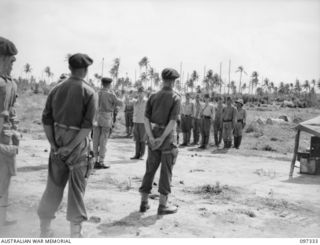 RAPOPO AIRSTRIP, NEW BRITAIN. 1945-09-28. AUSTRALIAN ARMOURED OFFICERS AND JAPANESE OFFICERS CONFER ON DETAILS OF THE CHANGE OVER AT THE AIRSTRIP AS AUSTRALIAN TANK CREWS OF 2/4 ARMOURED REGIMENT ..