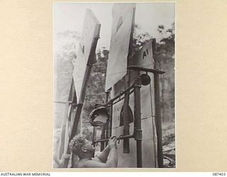HERBERTON, QUEENSLAND. 1945-03-08. PRIVATE W.C. DUNN, 2/1 GUARD REGIMENT, RAISING NO. 2 TARGET AT THE BUTTS OF THE HERBERTON RIFLE RANGE DURING THE GENERAL OFFICER COMMANDING 9 DIVISION GOLD MEDAL ..